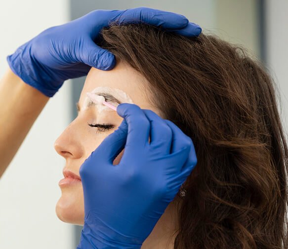 beautician doing eyebrow treatment her female client (1) 1