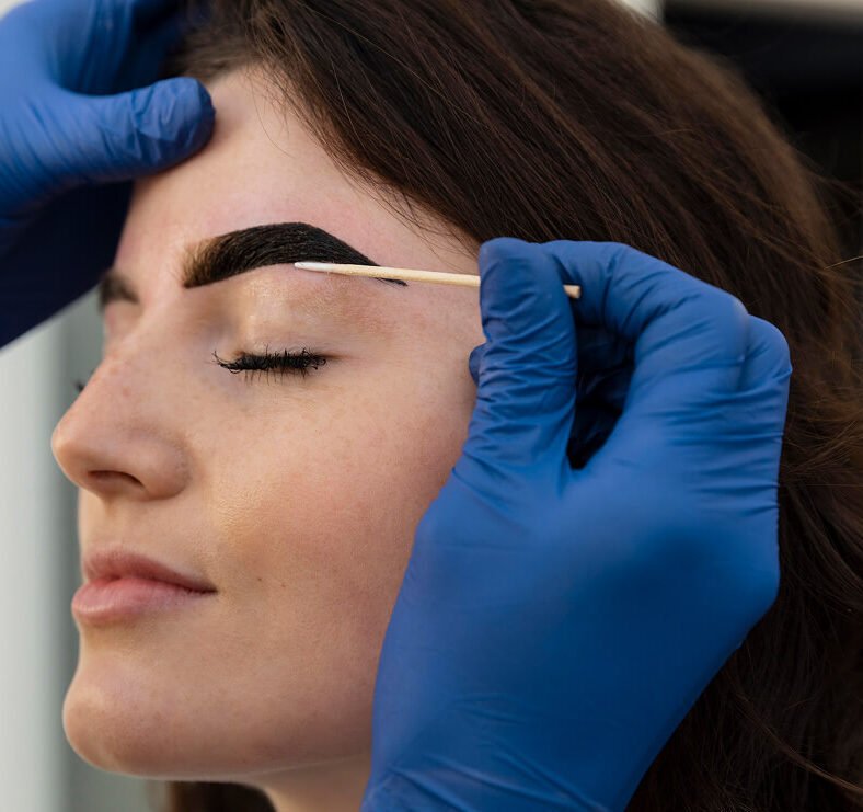 woman getting eyebrow treatment beauty salon (1) 1