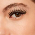 Home woman with eyelashes extension side view